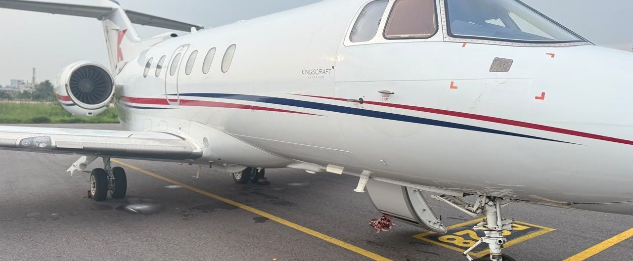 Side view of the Hawker 900XP private jet on the apron