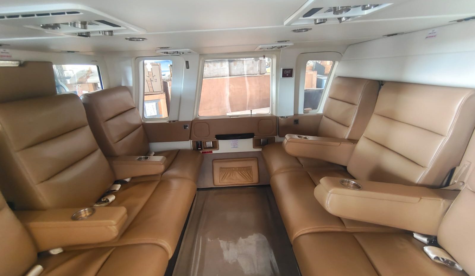 Tan leather club seating inside the Sikorsky S-76C++ VIP cabin
